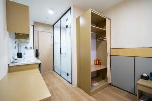 a small room with a closet and a sink at Zhuoya Garden Hotel in Beijing