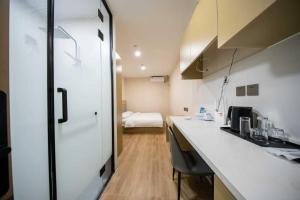 a kitchen with a counter and a room with a bed at Zhuoya Garden Hotel in Beijing