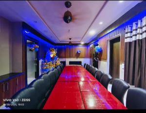 a large conference room with a long table and chairs at Hotel Bhumi Residency in Pānīpat