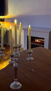 a group of candles on a table with a fireplace at Studio Balcescu in Sibiu
