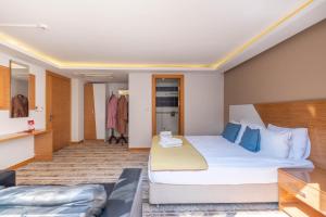 a hotel room with a large bed and a couch at Bulvar Hotel in İzmir