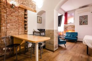 a room with a table and chairs and a bed at Medieval central apartment in Bologna +23 photos