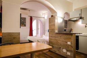 a small kitchen with a table in a room at Medieval central apartment in Bologna