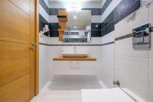 a bathroom with a sink and a mirror at Bulvar Hotel in İzmir