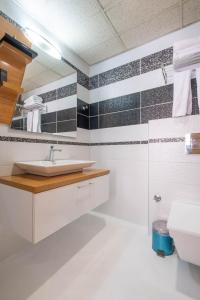 a bathroom with a sink and a mirror at Bulvar Hotel in İzmir