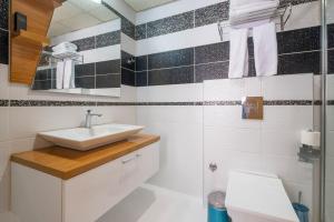 a bathroom with a sink and a toilet at Bulvar Hotel in İzmir