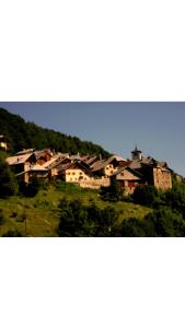 a group of houses on top of a hill at Auberge de l'eau rousse in La Léchère