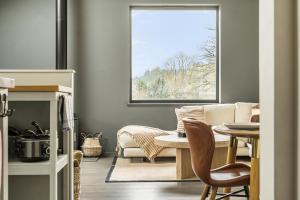 a living room with a couch and a table at Grove Cottage in Kington +45 photos