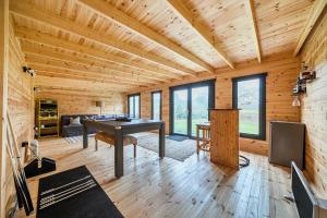 a room with a ping pong table in a log cabin at Grove Cottage in Kington