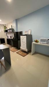 a kitchen with a counter and a refrigerator in it at Flat JK 101 in Juazeiro do Norte
