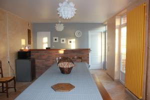 a kitchen with a table with a basket on it at Gîte with pool & Nordic bath in Monthois