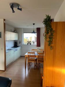a kitchen and dining room with a table and chairs at Ark in Terherne
