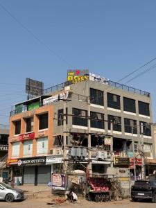a tall building with a lot of signs on it at The 7 elevan hotel in Sānand