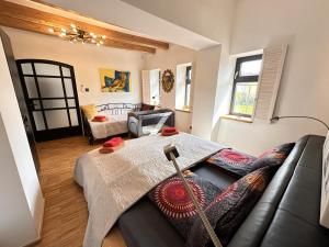 a living room with a couch and a bed at VizslaVilla in Poroszló
