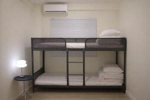 a room with two bunk beds in a room at The loft 6 in Busan