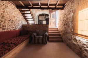 a hallway with a couch and a chair in a building at Vertigo Stone Villa - Roumeli Private Pool Escape in Roumelí +27 photos