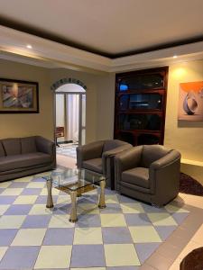a living room with two couches and a coffee table at Capri Hills 4 in Mwanza