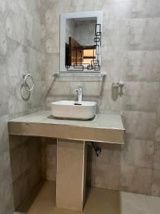 a bathroom with a sink and a mirror at Capri Hills 4 in Mwanza