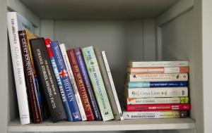 a bunch of books sitting on a shelf at Pennan - 2 Bed Luxury Apartment by Together Travel in Wick