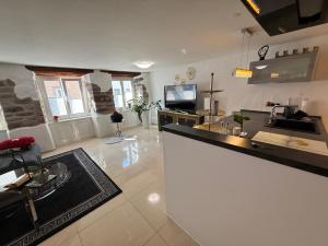 a large kitchen with a counter top and a tv at Luxus Domizil in Villingen-Schwenningen