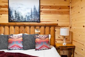 a bedroom with a bed and a picture on the wall at Bison Trail House- Rustic Cabin Retreat in Rapid City