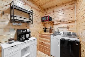 a kitchen with a sink and a stove at Bison Trail House- Rustic Cabin Retreat in Rapid City +21 photos
