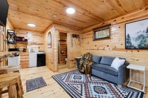 a living room with a blue couch in a log cabin at Bison Trail House- Rustic Cabin Retreat in Rapid City