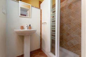 a bathroom with a sink and a shower at Casa Lampadina in Vižinada +26 photos
