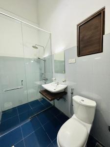 a bathroom with a toilet and a sink at Heriance Anuradhapura in Tammannewa