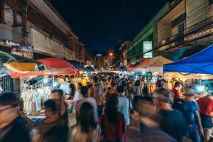 a crowd of people walking through a market at night at Allrange Home 5 bedroom for 10 guests in Chiang Mai