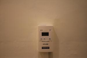 a white soap dispenser hanging on a wall at The loft 6 in Busan +11 photos