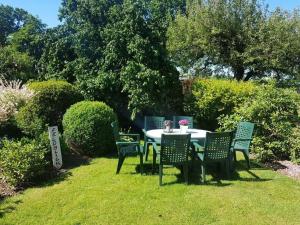 a table and chairs sitting in a yard at Feldblick in Ruhwinkel