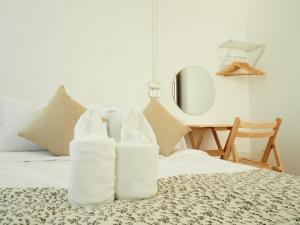 a pair of white boots sitting on top of a bed at Allrange Home 5 bedroom for 10 guests in Chiang Mai
