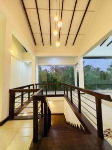 a room with a balcony with a large window at Heriance Anuradhapura in Tammannewa