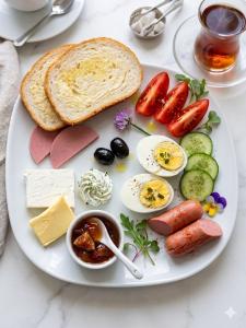 a plate of food with eggs meats and bread at Baku City Inn Boutique Nizami Hotel in Baku