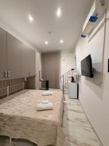 a bedroom with a large bed with two towels on it at B&B Heracleae Luxury Home in Cattolica Eraclea