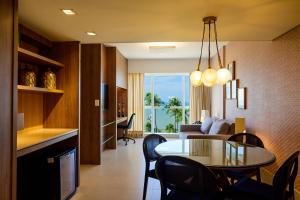 a living room with a table and a dining room at Hotel Beira Mar in Fortaleza