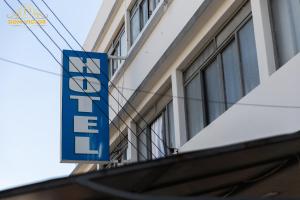 a blue sign on the side of a building at Dom Victor Residence Hotel in Goiânia