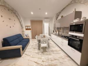 a living room with a blue couch and a table at B&B Heracleae Luxury Home in Cattolica Eraclea