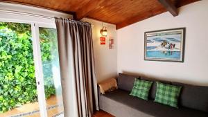 a living room with a couch and a window at Casa Rustica - Entire Courtyard House - Sunny Patio in Olhão
