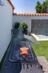 a grill in a yard with a food on it at El Refugio del Agua - Casa Rural in Valsequillo +20 photos