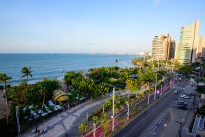 a city street with the ocean in the background at Hotel Beira Mar in Fortaleza
