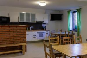 a kitchen and dining room with tables and chairs at Penzion Púrynky in Velké Bílovice +18 photos