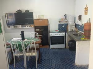 a small kitchen with a table and a sink at Cantinho da paz in São Roque +24 photos
