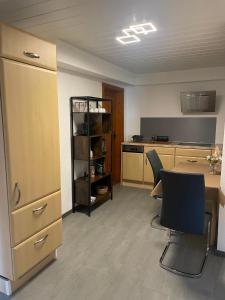 a kitchen with a table and chairs in a room at Ferienwohnung Wiesenweg in Friedrichroda