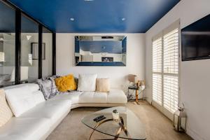 a living room with a white couch and a blue ceiling at Main House in Rotherham +7 photos