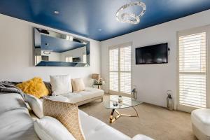 a living room with white furniture and a blue ceiling at Main House in Rotherham