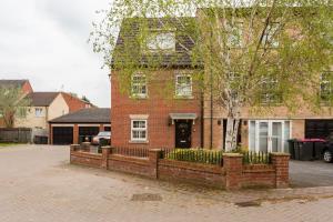 a brick house with a fence in front of it at Main House in Rotherham