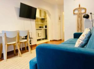 a living room with a blue couch and a table at Bairro Alto Cozy apartment in Lisbon +15 photos