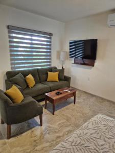 a living room with a couch and a coffee table at Hotel Lorimar in La Paz